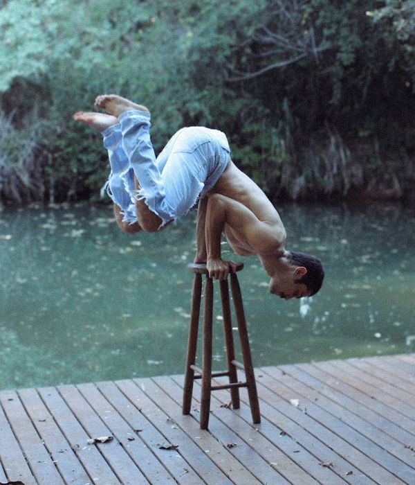 Man performing a controlled strength exercise with calm focus.